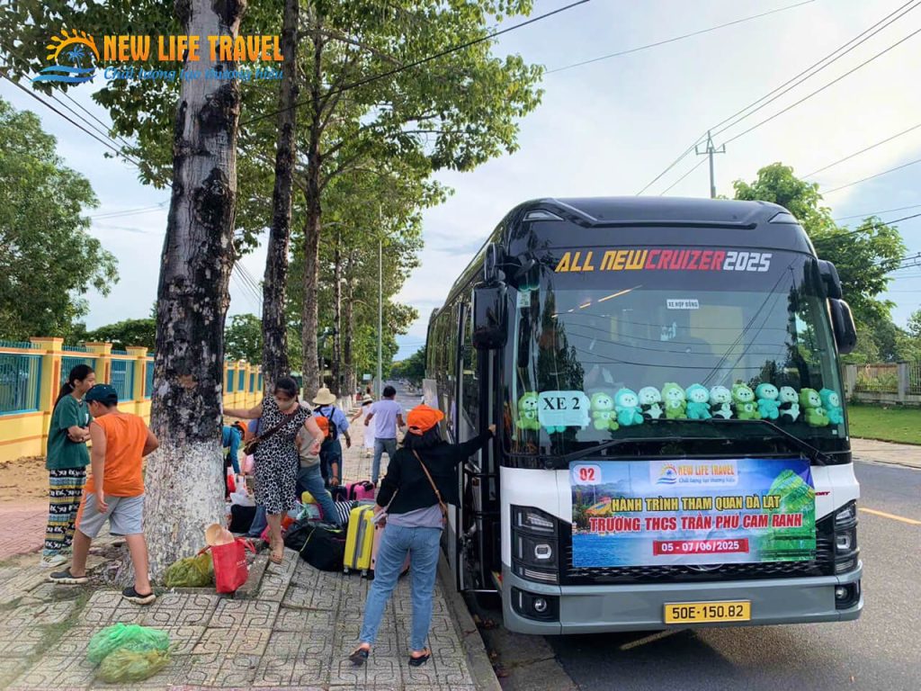 Group of tourists boarding private 29-seater passenger bus for excursion from coastal Nha Trang to Da Lat